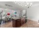 Open kitchen featuring an island with granite counters, wood floors, and stainless steel appliances at 9132 Colwick Hill Ln, Charlotte, NC 28215