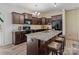 Kitchen area featuring an island with granite counters, wood cabinets, stainless steel appliances, and bar stool seating at 9132 Colwick Hill Ln, Charlotte, NC 28215