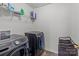 Efficient laundry room with modern washer and dryer units and ample storage shelving at 9132 Colwick Hill Ln, Charlotte, NC 28215
