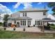Spacious backyard features a white exterior, stone patio, and a gazebo with string lights at 916 Cadogan Ct, Fort Mill, SC 29708
