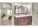 Bathroom featuring a double sink vanity and view into the primary bedroom at 916 Cadogan Ct, Fort Mill, SC 29708