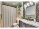 Charming bathroom with a floral wallpaper, a mirror, and a shower-tub combination at 916 Cadogan Ct, Fort Mill, SC 29708