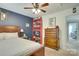 Bedroom featuring a bed, dresser, and wall decor in a cozy setting at 916 Cadogan Ct, Fort Mill, SC 29708