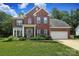 Beautiful two-story brick home with a well-manicured lawn and attached two car garage at 916 Cadogan Ct, Fort Mill, SC 29708