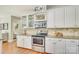 Bright kitchen features stainless steel appliances, granite countertops, and classic white cabinetry at 916 Cadogan Ct, Fort Mill, SC 29708