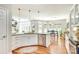 Spacious kitchen with stainless steel appliances, white cabinetry, and views into the dining and living areas at 916 Cadogan Ct, Fort Mill, SC 29708