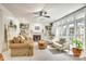 Cozy living room with built-in shelving, fireplace, and an abundance of natural light at 916 Cadogan Ct, Fort Mill, SC 29708