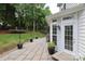 Stone patio with string lights and well-manicured backyard with a trampoline at 916 Cadogan Ct, Fort Mill, SC 29708
