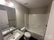 Clean bathroom with granite vanity, shower-tub combo, and contemporary fixtures at 003 West Ave, Wadesboro, NC 28170
