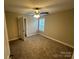 Comfortable bedroom featuring neutral tones, a ceiling fan, and a large window for natural light at 003 West Ave, Wadesboro, NC 28170