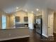 Bright and airy kitchen featuring modern appliances, granite countertops, and stylish gray cabinetry at 003 West Ave, Wadesboro, NC 28170