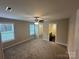 Main bedroom with a ceiling fan, plush carpeting, and an en-suite bathroom at 003 West Ave, Wadesboro, NC 28170