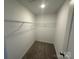 Bright walk-in closet featuring neutral carpeting and wire shelving for optimal storage solutions at 004 West Ave, Wadesboro, NC 28170