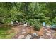 A serene backyard featuring a seating area with lush greenery and mulched ground at 1006 Washburn Ct, Monroe, NC 28110