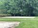 Outdoor basketball court available for residents' recreational use, surrounded by lush greenery and trees at 1006 Washburn Ct, Monroe, NC 28110