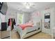 Bright bedroom features white walls, a ceiling fan, and a patterned pink comforter at 1006 Washburn Ct, Monroe, NC 28110