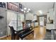 Open dining area with modern chandelier, stone table, and wooden floors at 1006 Washburn Ct, Monroe, NC 28110