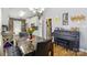 Open dining area features a stone table with black leather seating and a black piano at 1006 Washburn Ct, Monroe, NC 28110