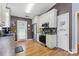 Modern kitchen with stainless steel appliances, wood floors, and white cabinets at 1006 Washburn Ct, Monroe, NC 28110