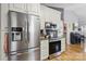 Modern kitchen with stainless steel appliances and white cabinets open to dining area at 1006 Washburn Ct, Monroe, NC 28110