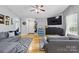 Open-concept living room with hardwood floors, ceiling fan and comfortable seating at 1006 Washburn Ct, Monroe, NC 28110