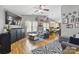 Open-concept living room with hardwood floors, ceiling fan and comfortable seating at 1006 Washburn Ct, Monroe, NC 28110