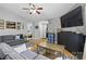 Open-concept living room with hardwood floors, ceiling fan and comfortable seating at 1006 Washburn Ct, Monroe, NC 28110