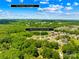 Overhead view of neighborhood with a distant view of Town of Harrisburg nestled among lush greenery at 10901 Greenvale Dr, Harrisburg, NC 28075