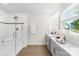 Bright bathroom featuring a glass shower, double sink vanity, and neutral color palette at 10901 Greenvale Dr, Harrisburg, NC 28075