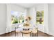 Cozy breakfast nook features a round table, four chairs, and two windows providing ample natural light at 10901 Greenvale Dr, Harrisburg, NC 28075