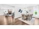An open dining area with light wood floors, neutral decor, and abundant natural light creates an inviting space at 10901 Greenvale Dr, Harrisburg, NC 28075