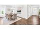 Bright dining room with wood floors, decorative lighting, and neutral paint provides an inviting atmosphere at 10901 Greenvale Dr, Harrisburg, NC 28075