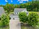A stunning two-story home boasts a three-car garage, driveway and is surrounded by lush greenery at 10901 Greenvale Dr, Harrisburg, NC 28075
