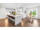 Bright kitchen with a large island, stainless steel appliances, and a breakfast nook with hardwood floors at 10901 Greenvale Dr, Harrisburg, NC 28075