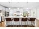 Bright, modern kitchen with a large island, stainless steel appliances, and stylish pendant lighting at 10901 Greenvale Dr, Harrisburg, NC 28075