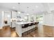 Well-lit kitchen with a large island, stainless steel appliances, and access to the outdoor area at 10901 Greenvale Dr, Harrisburg, NC 28075