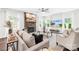 Cozy living room with stone fireplace, plush seating, and large windows for abundant natural light at 10901 Greenvale Dr, Harrisburg, NC 28075