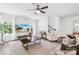 Bright living room featuring hardwood floors, a ceiling fan and large windows for natural light at 10901 Greenvale Dr, Harrisburg, NC 28075