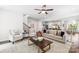 Open-concept living area with stylish furniture, hardwood floors, flowing into the kitchen at 10901 Greenvale Dr, Harrisburg, NC 28075