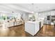 Open-concept living space featuring a modern kitchen, cozy living room, and elegant staircase at 10901 Greenvale Dr, Harrisburg, NC 28075