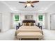 Main bedroom featuring neutral walls, a ceiling fan, carpet, a large bed and natural lighting at 10901 Greenvale Dr, Harrisburg, NC 28075