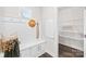 Mudroom with bench, storage cabinets, hooks, and an open closet with wire shelving at 10901 Greenvale Dr, Harrisburg, NC 28075