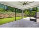 Inviting screened porch features a ceiling fan and outdoor views at 10901 Greenvale Dr, Harrisburg, NC 28075