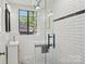 Modern bathroom features a shower with glass door, black hardware, and classic tile design at 1121 Myrtle Ave # 72, Charlotte, NC 28203