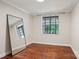 Empty bedroom featuring gleaming hardwood floors and natural light from the window at 1121 Myrtle Ave # 72, Charlotte, NC 28203