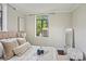 Bright bedroom featuring a window with a view, tray, plush pillows, and elegant decor at 1121 Myrtle Ave # 72, Charlotte, NC 28203