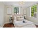 Serene bedroom featuring a plush bed, decorative pillows, artwork, and natural lighting from multiple windows at 1121 Myrtle Ave # 72, Charlotte, NC 28203