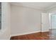 Empty bedroom featuring hardwood floors, neutral walls, and doorway to another room at 1121 Myrtle Ave # 72, Charlotte, NC 28203