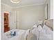 A cozy bedroom featuring a tray, plush pillows, a bedside lamp, and a glimpse into another room at 1121 Myrtle Ave # 72, Charlotte, NC 28203