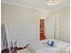 A bright bedroom featuring a tray, hardwood floors, modern lighting and a glimpse into another room at 1121 Myrtle Ave # 72, Charlotte, NC 28203